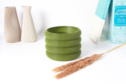 A single Aspen Ribbed Indoor Planter by EarthConcepts in forest green. This modern minimalist planter has a 5-inch diameter, perfect for adding style to home decor.